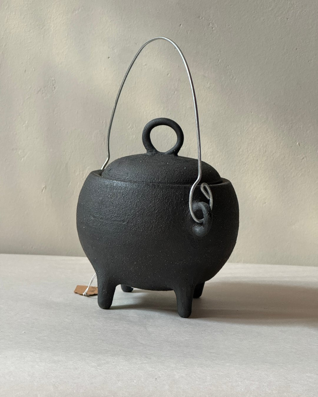 black ironstone ceramic cauldron with metal wire handle
