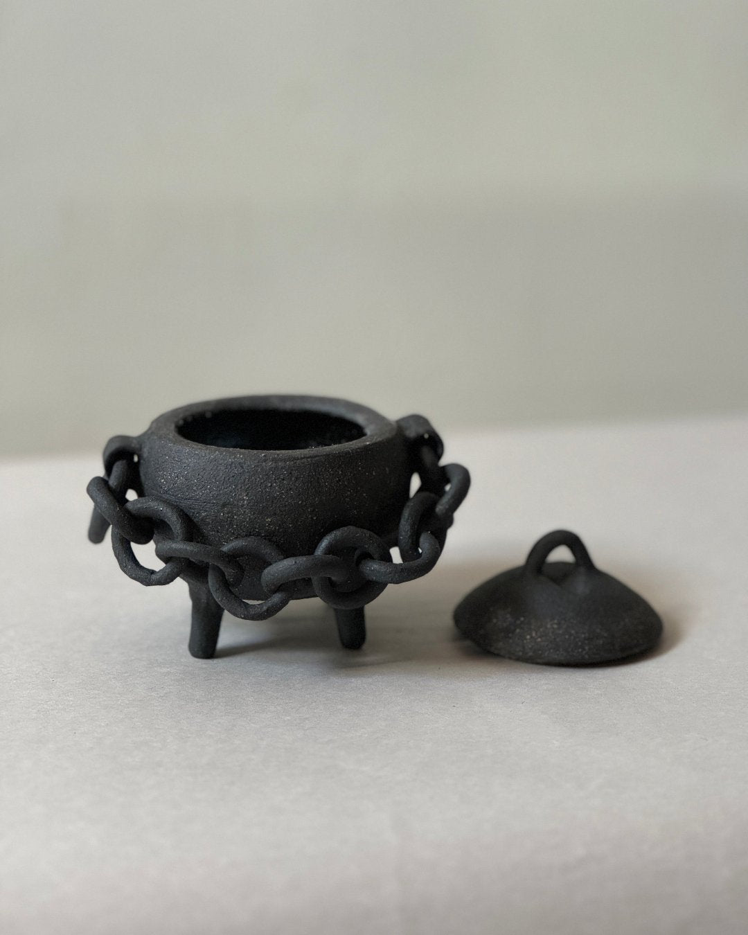 black ironstone cauldron with ceramic chain handle
