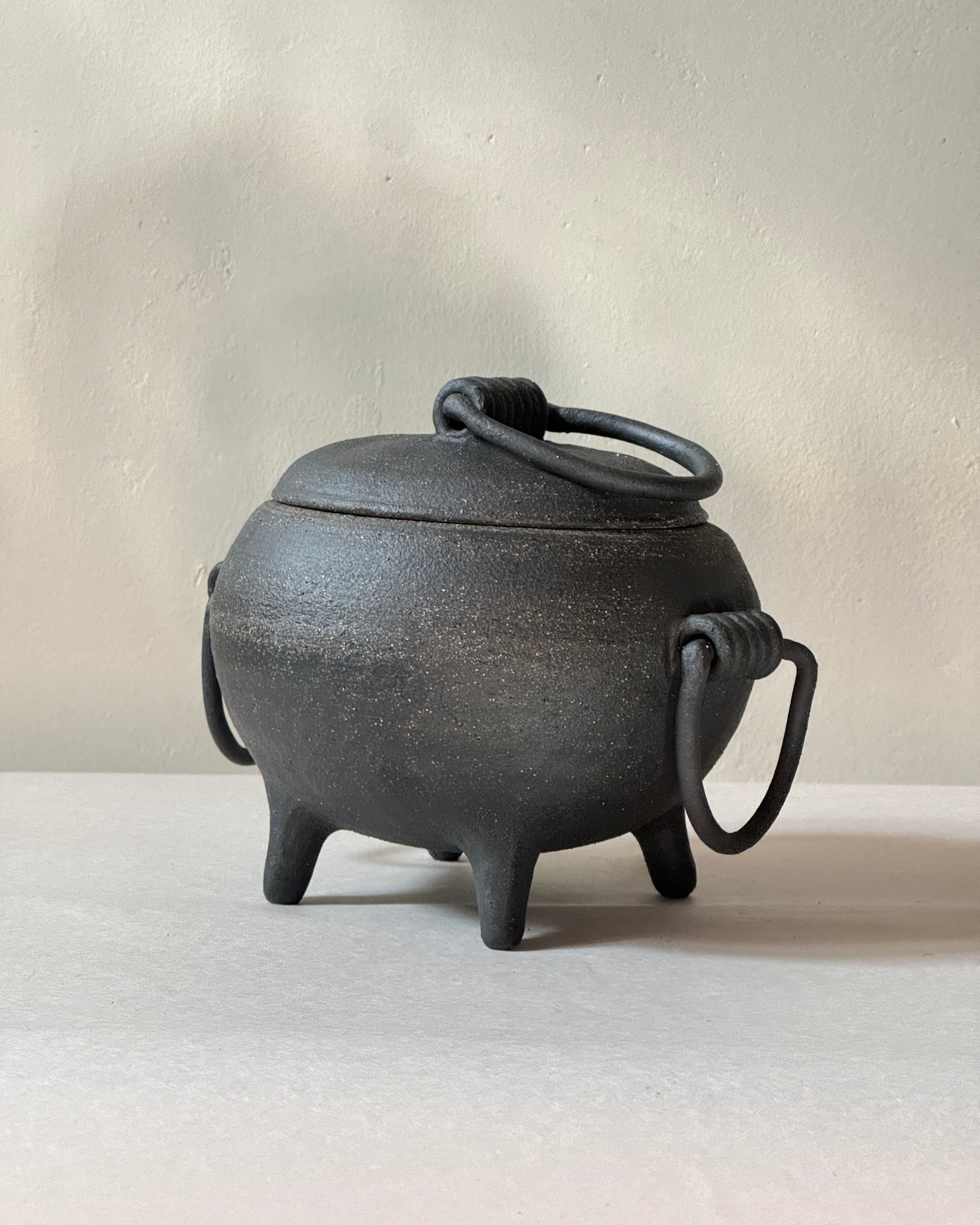 black ironstone ceramic cauldron with coil handles