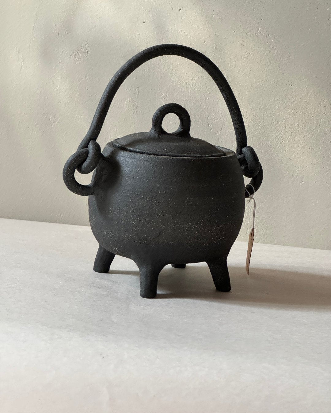 black ironstone ceramic cauldron with handmade ceramic handle