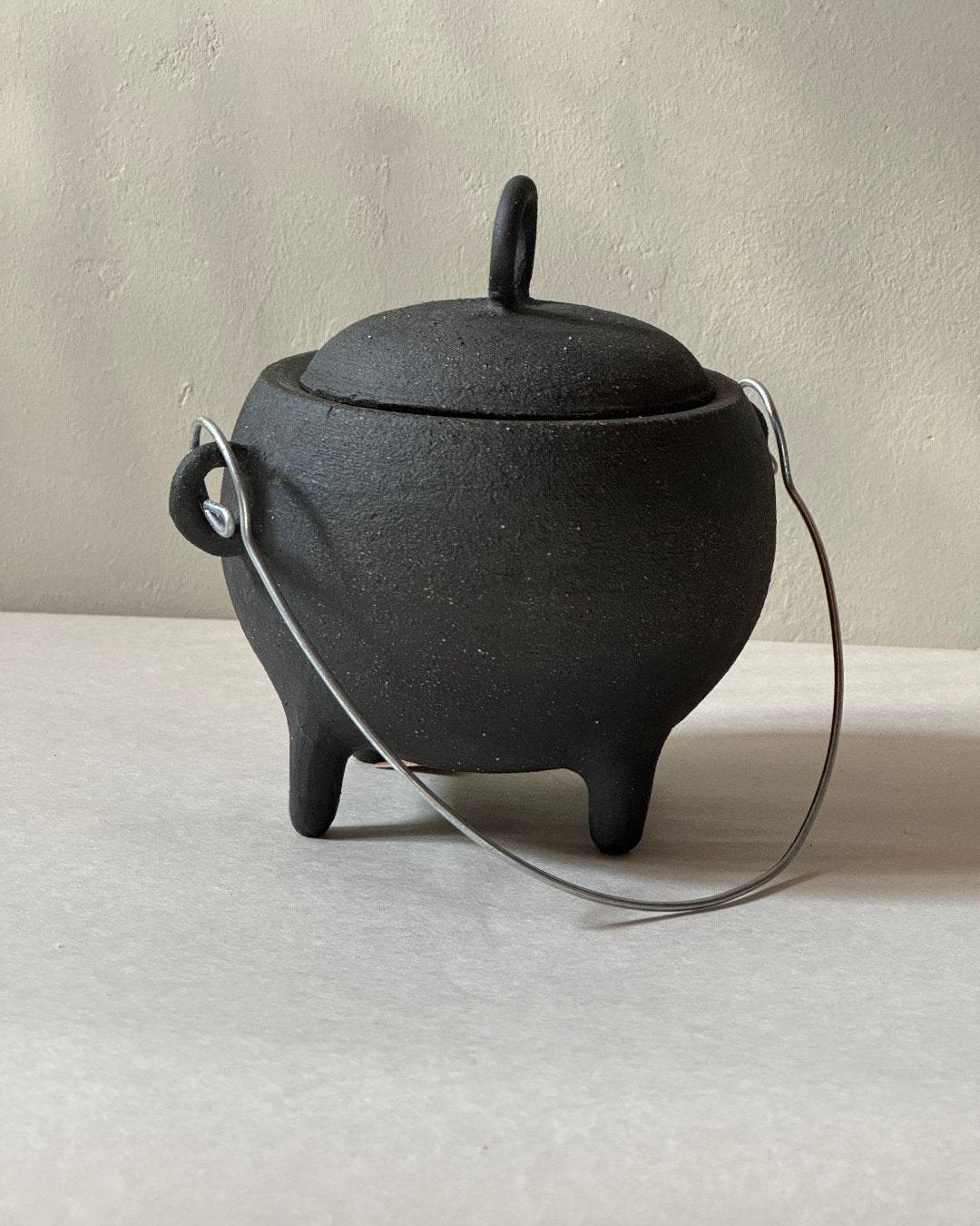 black ironstone ceramic cauldron with metal wire handle