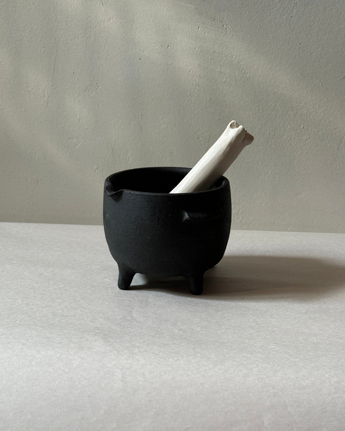 black ironstone ceramic mortar and pestle with ceramic bone shaped pestle