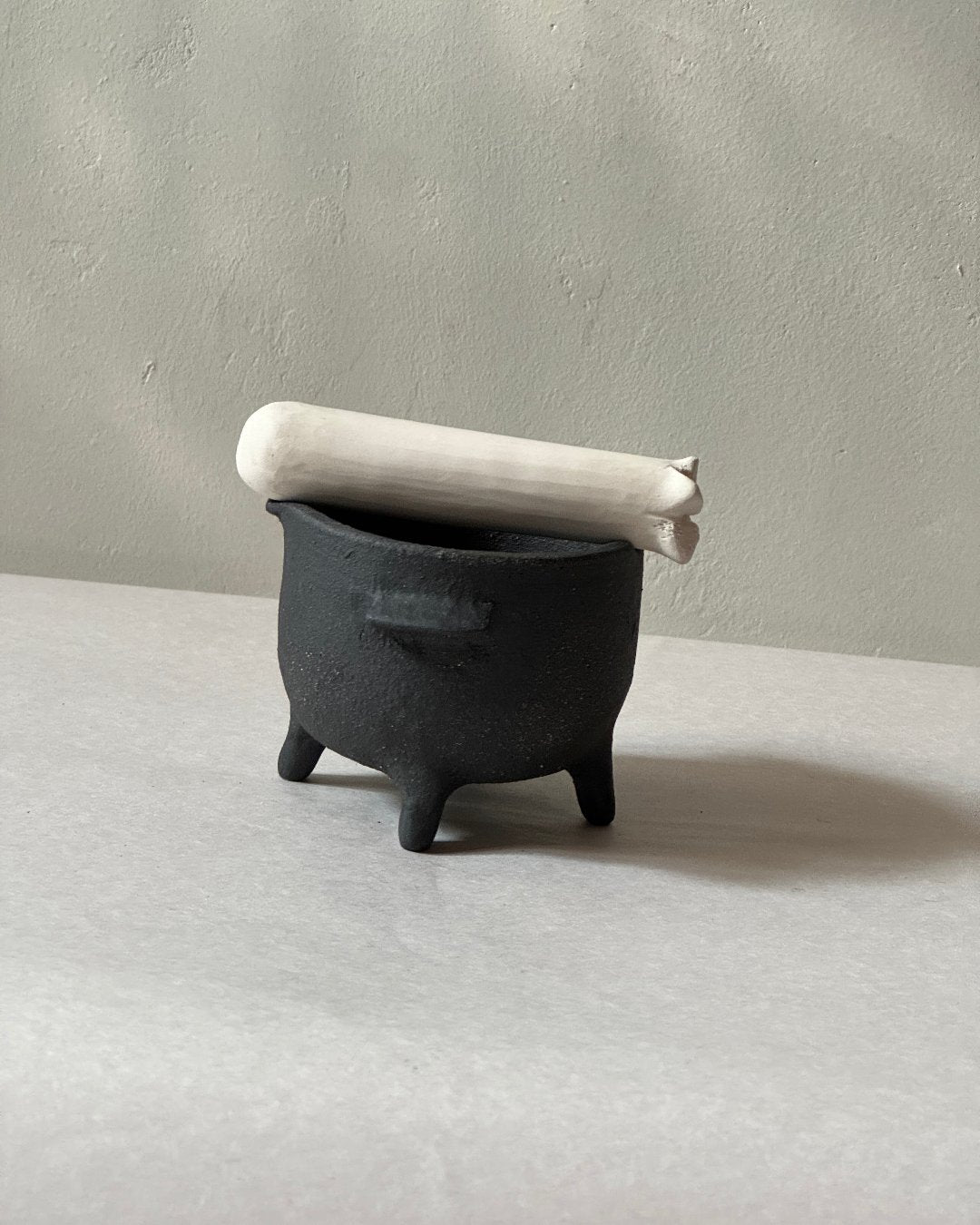 black ironstone ceramic mortar and pestle with ceramic bone shaped pestle